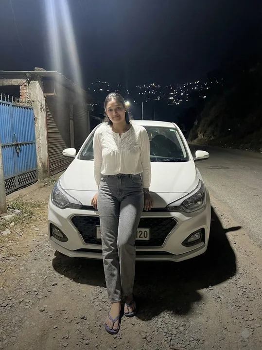 Figure in Front of the Car Under the Night Light Column