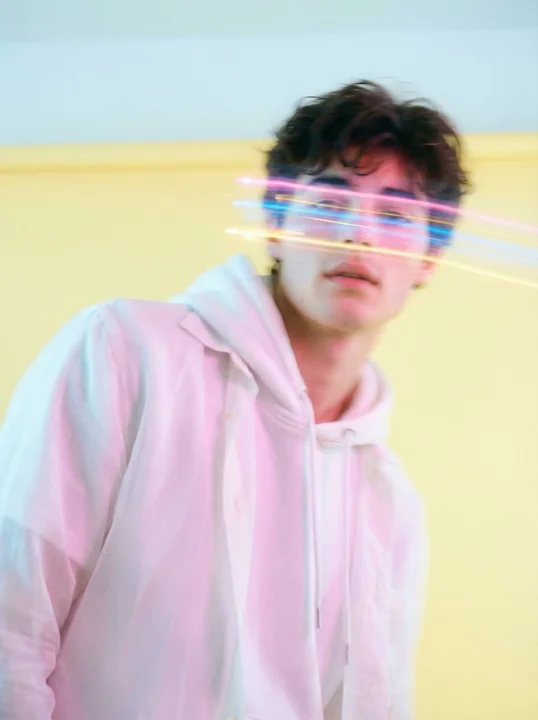 Dreamy Korean-style boy painted with pastel light trails
