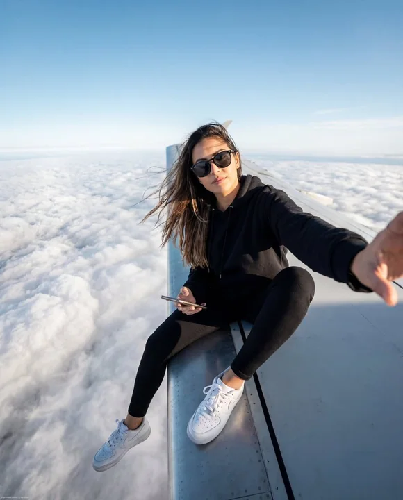An ultra-cool, edgy selfie on the wing of a cloudborne aircraft