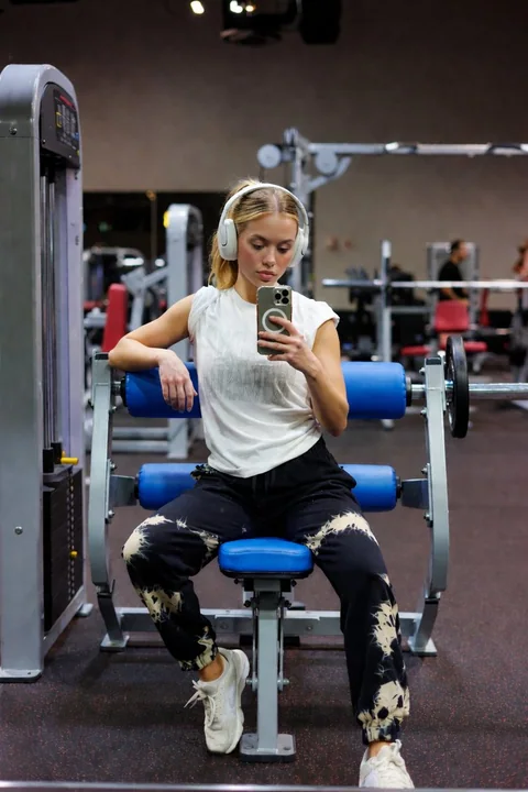 Fille brune à la salle de sport, autoportrait devant le miroir