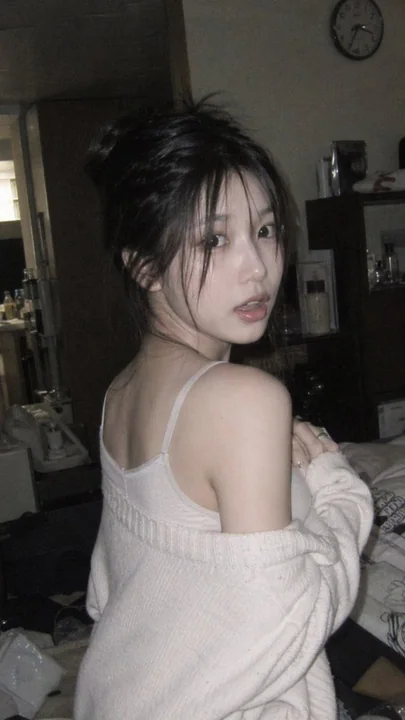 薄明な室内で純真な少女の不意に振り返る様子